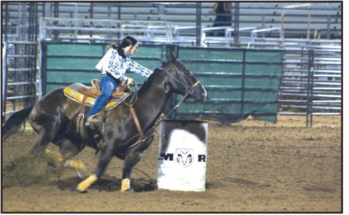Jessica Staff of Tecumseh rounds the second barrel in the second round of barrel racing at the IFYR on July 12. Countywide &amp; Sun/Natasha Dunagan