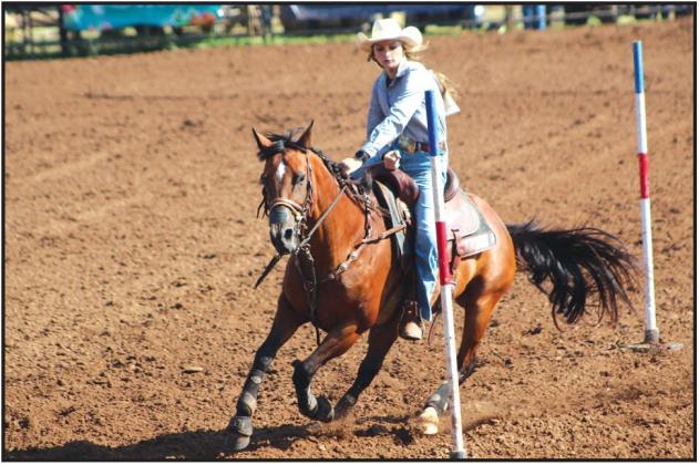 Cassidy Wilson of Shawnee navigates through the poles during the second round of the IFYR on July 13. Countywide &amp; Sun/Natasha Dunagan