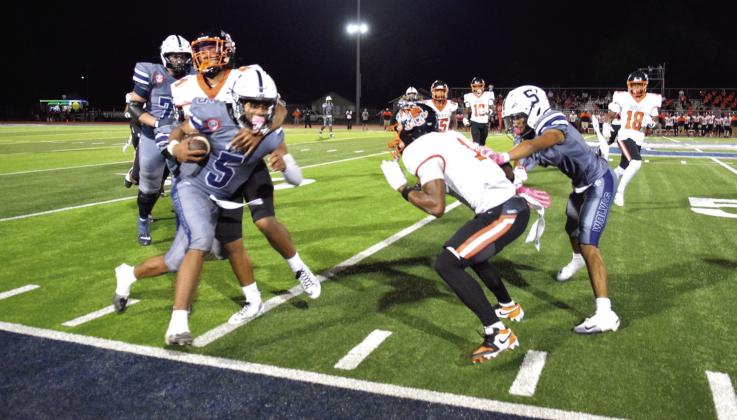Braylon Lassiter heads out of bounds after securing the first down on Oct. 3 in the game against Booker T. Washington. SHS won, 34-27.