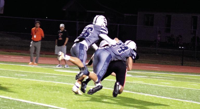 Jayden Smith and Riley Storie bring down the Booker T. ball carrier.