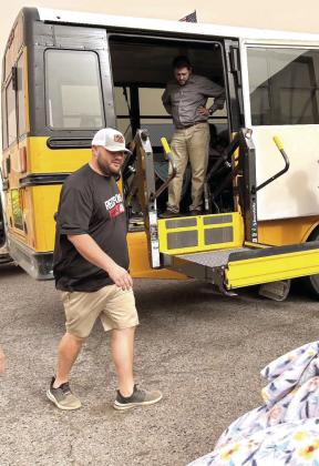 McLoud Assistant Principal Trey Aubert (left) and Mayor Daniel McClure (in the bus) are ready to load patients for the evacuation. Aubert also drove one of the buses. Photo provided