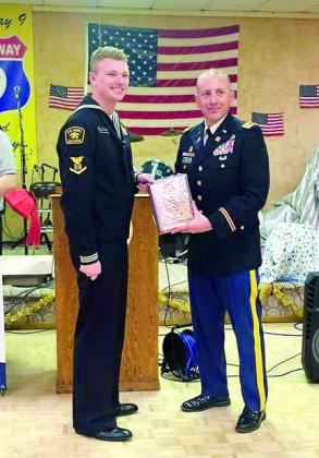 Petty Officer Callan Weathington receives the U.S. Naval Sea Cadet of the Year Award from Colonel Lukas Toth at American Legion Post #260 in Tecumseh on Dec. 17. Photo provided by Donna Snodgrass.