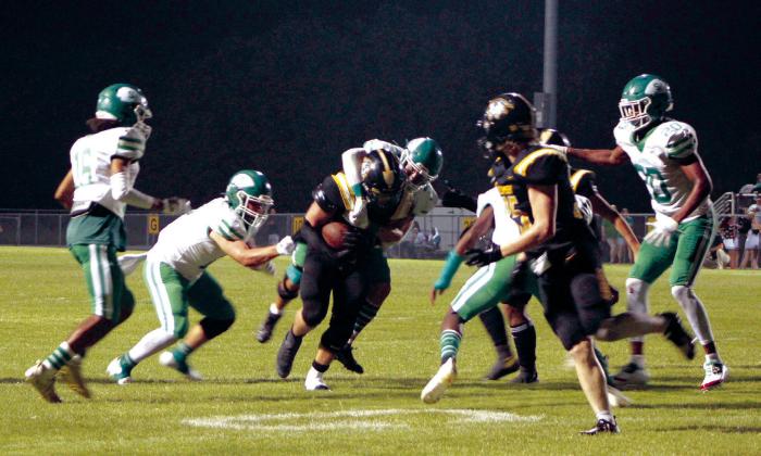 Tecumseh senior Garrett Chaffin carries the ball as two Seminole players try to take him down during the first home game on Sept. 9. Principal Randy Dilbeck said attendance was “at capacity,” and the Savages won 34-8. Countywide &amp;amp; Sun/Natasha Dunagan