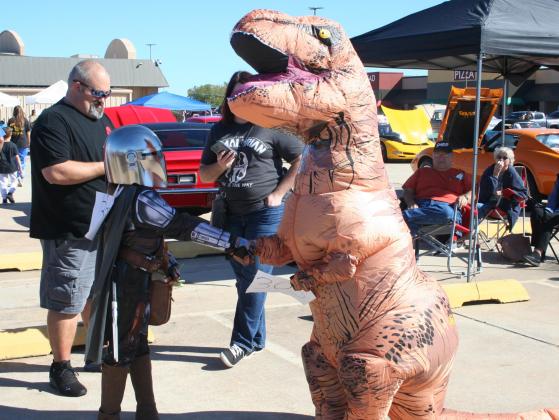 Eleven-year-old Colby Duroy (right) shakes hands with a fellow costume contest contestant dressed as the Mandalorian, while gathering for the contest. The costume contest took place at the 17th Annual FireLake Casino Car Show, Oct. 16. See more photos on page B7. Countywide &amp;amp; Sun/Kendra Johnson