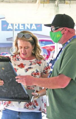 Robyn Morse accepts the Best of Show award on her husband Donnie Morse’s behalf at the FireLake Casino Annual Car Show, Oct. 16. Brad Duncan (not pictured) and Kevin Huffine (right) presented the award.