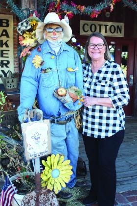 Deann Smith, owner of Farmer’s Daughter Market, at 302 N. Broadway, stands by their scarecrow, “Honey Dew Jim,” who won first place in the City of Tecumseh Commercial Scarecrow Contest on Oct. 21. The scarecrow looks very similar to her husband, Jim. There were ten scarecrows in the commercial contest. Countywide &amp;amp; Sun/Natasha Dunagan