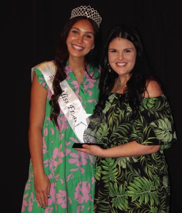 Katie McMahan, of Athletico, accepts the Rising Star Award from Miss Frontier Days Jalee Meyers. McMahan was also named Business Person of the Year.