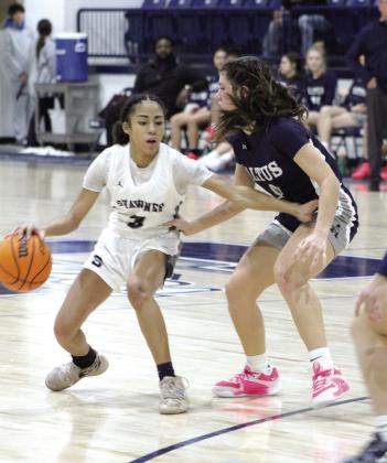 Shawnee sophomore Tarilynn Thierry guards the ball from from an Altus defender during their last regular season home game on Feb. 9. The Lady Wolves won, 59-35, and have a record of 15- 7.