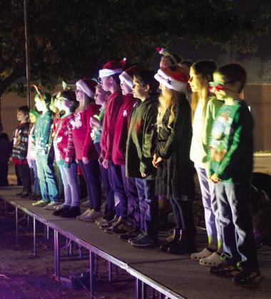 The Sequoyah Elementary Honor Choir sings Christmas carols at the Celebration of Life Park during the Shawnee Tree Lighting event on Nov. 17. Choirs from Horace Mann and Jefferson elementaries also sang.