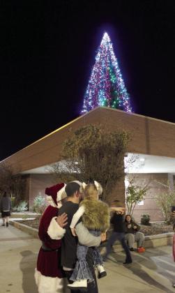 Santa Claus takes a few more pictures with kids outside the Shawnee Pioneer Library during the Shawnee Tree Lighting event on Nov. 17. Countywide &amp; Sun/Natasha Dunagan