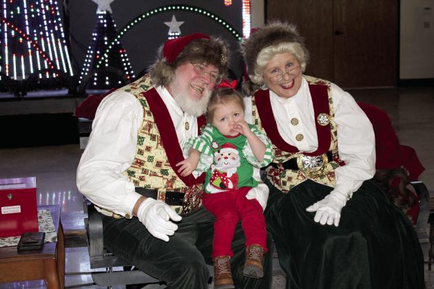 Sylar Coble, 2, of Meeker, poses with Santa and Mrs. Claus at the Paul and Ann Milburn Center, in Shawnee, on Dec. 3. Santa will return to the Pottawatomie County history museum on Dec. 10, 1-4 pm. There will be no admission fee that day. An indoor light show can also be seen before Dec. 24. Photos by Countywide &amp;amp;Sun/ Natasha Dunagan