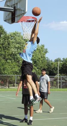 Earlsboro High School 2022 graduate Ryan Long dunks the ball, as SHS graduate Chevis Sharp, Jr. (hidden) and Bethel High School 2023 graduate Si Foreman watch, during the First Annual Hoops for Hope on July 25. Photos by Natasha Dunagan, Countywide &amp; Sun