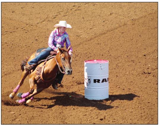 Koree Thompson, of Shawnee, rounds the second barrel in the IFYR Barrel Racing event on July 12 at the Heart of Oklahoma Expo Center. Countywide &amp; Sun/Natasha Dunagan