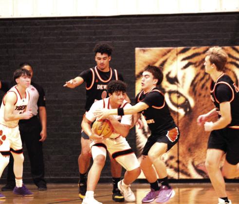 Maud's Jonathan Lamas grabs the rebound and defends it against Dewar in the fourth quarter of the Jan. 16 home game. The Tigers won 56-49. Earlier, the Lady Tigers lost 28-70.