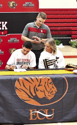 North Rock Creek's Cason Coomer signs his letter of intent to play baseball at ECU. Looking on is his mom Lisa Coomer and asst. NRC baseball coach Gant Hathcock. Photo courtesy of Gowin Photography
