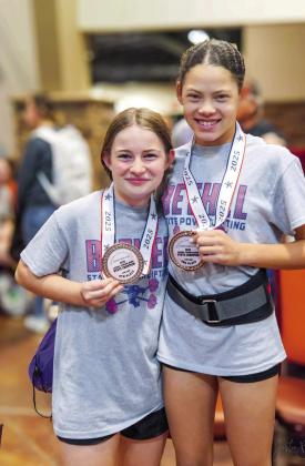 Picctured above from left is Kinsley Dunsworth and Evva Baker after receiving their medals. Photo provided by Coach Joey Ginn