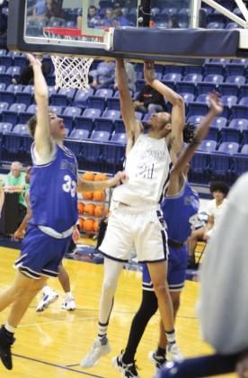 Shawnee’s Kayden Shaw goes to the bucket during the third quarter of the home game against Guthrie on Jan. 4.