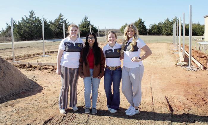 McLoud FFA Sentinel Madison Bickel, Historian Mayrin Perez, Treasurer Emma Bellah and Chaplain Austyn Wood stand in front of where the new McLoud FFA greenhouse is being constructed. The greenhouse was approved by the school board in July and was paid for with ESSER III funds. Countywide &amp;amp; Sun/Natasha Dunagan