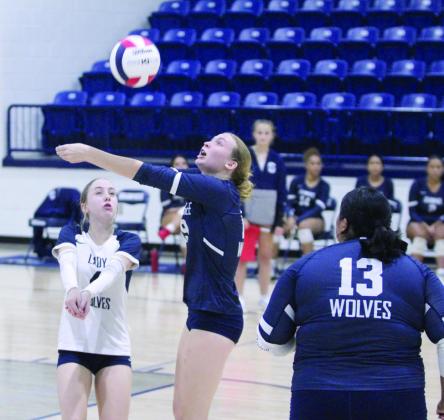 Shawnee’s Micah Teape makes a forearm pass, as Libero Kylee Moore backs her up at the home match with El Reno on Aug. 22. The Lady Wolves won, 3-0 (25-18, 25-12, 25-19).