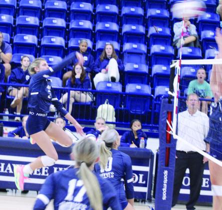 Shawnee’s Jordan Tash attacks the ball and send it flying at the home match with El Reno.