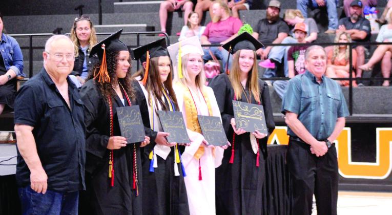 Walt Spicer, Secretary of the Maud-Konawa Masonic Lodge, far left, and John Tredway, the Maud Alumni President, far right, present combined scholarships to Maud graduates Amerikus Street, Raeyleigh Gensman, Shaelynn Fletcher and Jaycee Pack during the Maud High School Commencement Ceremony on May 23. Natasha Dunagan, Countywide &amp;amp; Sun