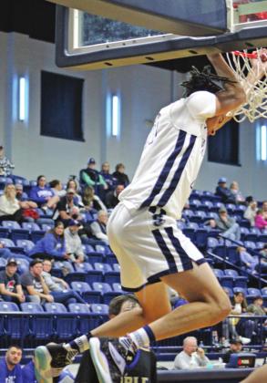 Shawnee senior Kayden Shaw slam dunks during the game against Noble on Feb. 18.