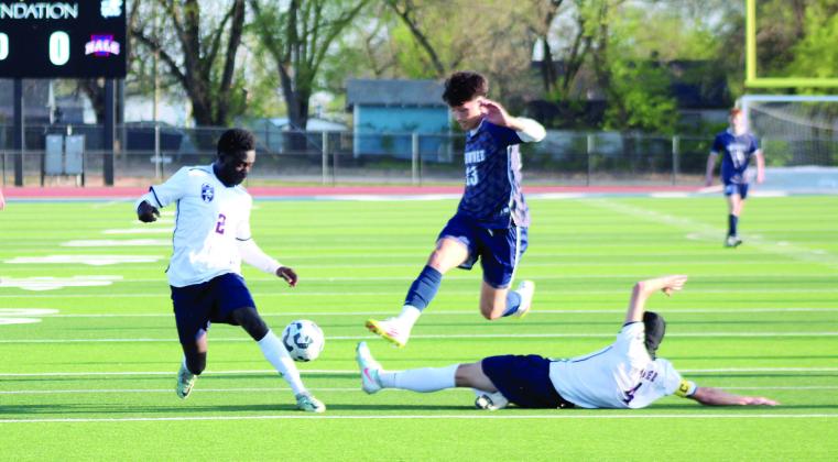 Shawnee junior Hayden Spears jumps over a Nathan Hale player while trying to keep possession of the ball. Natasha Dunagan, Countywide &amp; Sun
