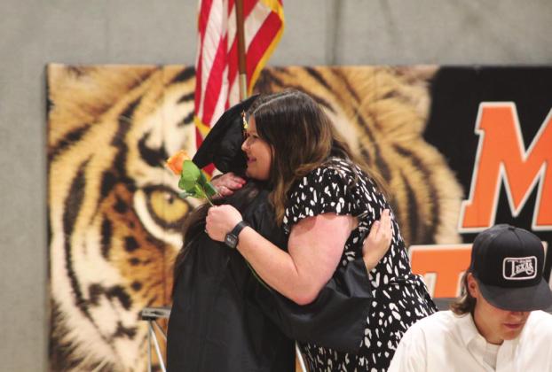 Above, Maud graduate Brooke Townsing gives a tulip and a hug to School Counselor Danyele Minton during Graduation Ceremonies on May 20 in the Ed Harmon Gym. Maud graduated 21 seniors.