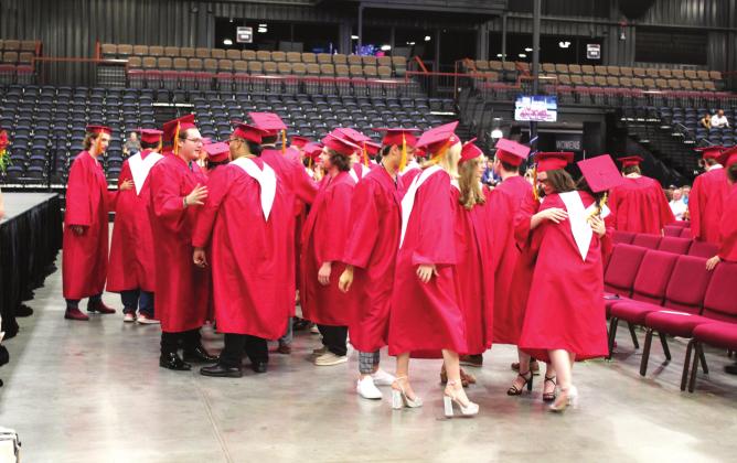 Dale’s Class of 2022 shares hugs and handshakes during their Moment of Reflection before receiving their diplomas at FireLake Arena on May 19. Dale graduated 47 seniors this year. Countywide &amp;amp; Sun/Natasha Dunagan