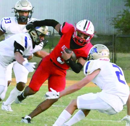 McLoud’s Jaydon Rard works to break through the Mannford defense in action Friday, Sept. 27. The Redskins beat Mannford 35-14. Photo provided