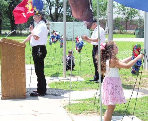 Sarah Jett places a wreath.