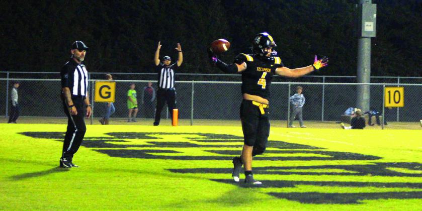 Tecumseh senior Garrett Chaffin holds up the ball after making a touchdown in the home game against Harrah on Oct. 7. The Savages won 13-6. Countywide &amp;amp; Sun/Natasha Dunagan
