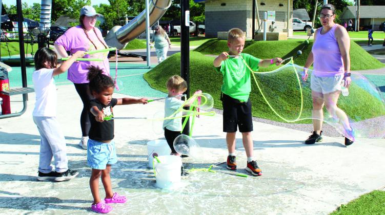 Children enjoy making bubbles from ropes with handles at the Gateway to Prevention &amp; Recovery booth during the Health Week 'Fun Day at KidSpace Park' on the evening of May 29. The Fun Day also included Shawnee Library's button maker, Pups and Pals, a Free-Throw Contest, Sweet Fixes Cooking Demo and the Community Connection Walk, plus other freeplay opportunities and food trucks. Natasha Dunagan, Countywide &amp;amp; Sun