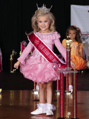 Autumn Hughes, 5, of Tecumseh, poses with her Our Diamond Miss Oklahoma State Talent crown, sash and trophy during the state pageant, which was held in Chickasha, June 7-9. Hughes won four of the five “Tiny” titles. Photo by Jerry Watson Photography.
