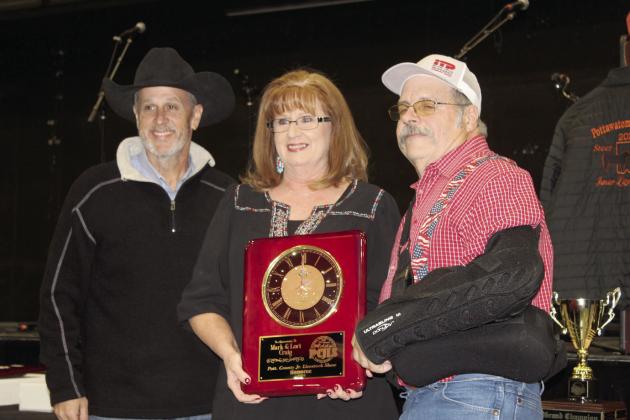 PCJLS Committee Member Matt Griffith, far left, presents a clock plaque to Honorees Lori and Mark Craig during the 35th Annual Pig Roast &amp; Trophy Auction on Feb. 5. Countywide &amp; Sun/Natasha Dunagan