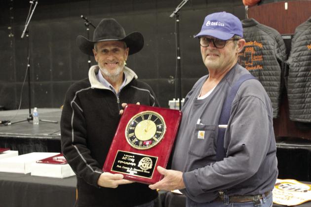PCJLS Committee Member Matt Griffith presents a clock plaque to Honoree Jeff Craig during the 35th Annual Pig Roast &amp; Trophy Auction on Feb. 5. Countywide &amp; Sun/Natasha Dunagan