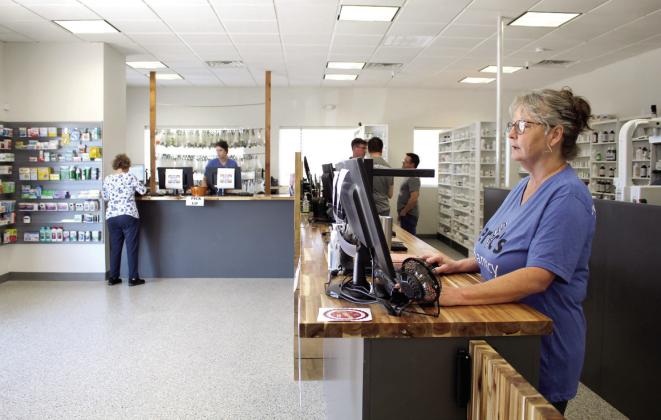 Pharmacy technician Paula Whitlock processes prescription orders at Eric’s Pharmacy’s new temporary location at 4151 N. Harrison, Shawnee, on June 29. Countywide &amp;amp; Sun/Natasha Dunagan