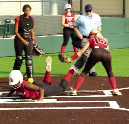 Earlsboro freshman Zory McGregor dives into home, as Macomb sophomore Rylee Hancock tries to tag her but loses the ball during the Little River Conference Tournament game on Sept. 4. Earlsboro junior Payten Gentry stole home shortly after McGregor. The Lady Wildcats beat the Lady Hornets, 6-2, in addition to winning three more games to become tournament champions. Natasha Dunagan, Countywide &amp;amp; Sun