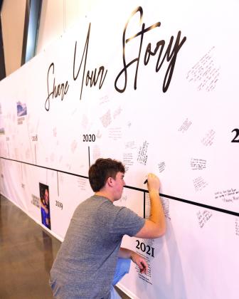 Members of Life.Church add their story to the 10 year4 timeline wall during the anniversary celebration. Photo provided