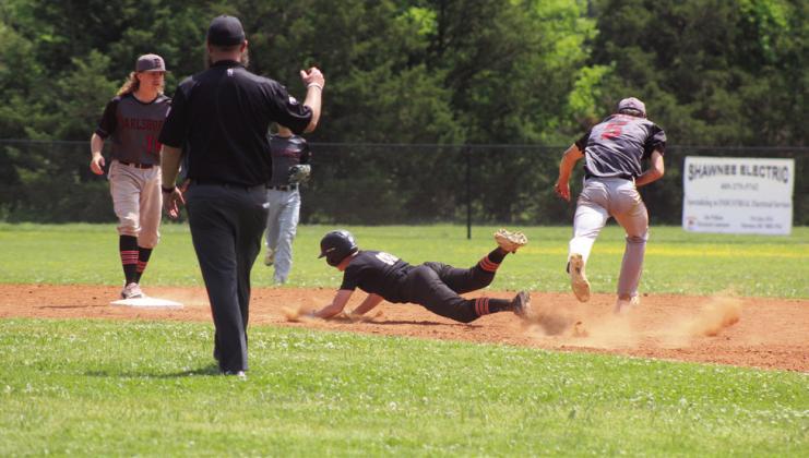 Maud’s Micah Brooks dives into second after being chased by Earlsboro’s Trystan Black (#5), as second-baseman Jonathan Wilkins (#19) watches.