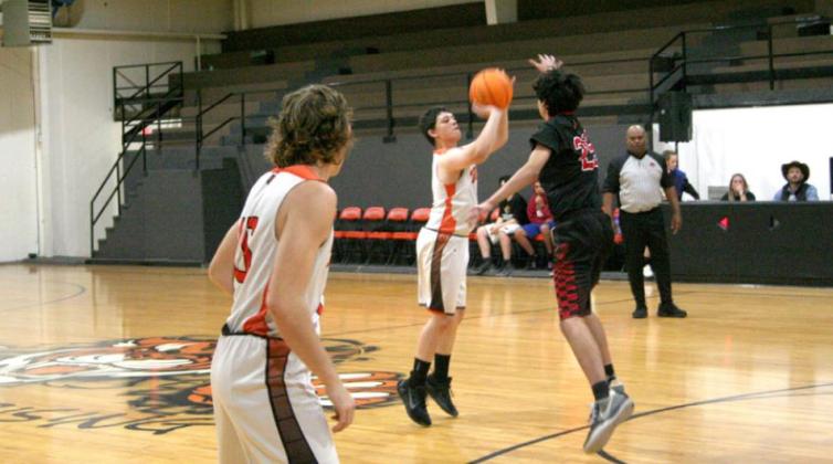 Carson Bourque (Wanette’s #4) scores a 3-pointer during the Tigers’ 60-33 win versus Victory Life Academy, Nov. 5.