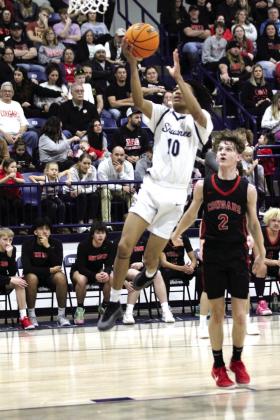 Shawnee senior Zyron Campbell makes a bucket as North Rock Creek junior Kohen Warden looks on during the Feb. 8 game at Shawnee. The Wolves lost, 53-61. Countywide &amp; Sun/Natasha Dunagan