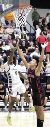 Shawnee senior Daytain Patton throws in two points during the Feb. 8 home game against North Rock Creek. Patton was recognized before the boys game for reaching 1,000 points recently.
