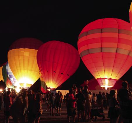 Hot-air balloons light up during the Balloon Glow on Friday, Aug. 9, at the FireLake Fireflight Balloon Festival. There were 25 balloons at the event this year, mostly from Oklahoma and the surrounding states. They also offered tethered rides and early morning balloon launches. File photo
