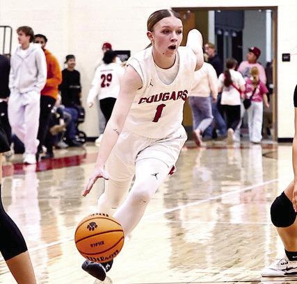 North Rock Creek Cougars hosted Bethel Jan. 16. Right: Addisen Lawrence drives up the lane. The Lady Wildcats won the matchup 53-38. The Cougars won their game 74-35.