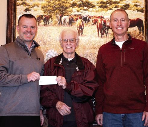 Dale Public Schools Superintendent Will Jones accepts a $6,500 check from Pottawatomie County Facilities Authority Trust Chairman Leonard Taron and Vice Chairman Tom Wilsie on Dec. 14.  Dale plans to use the funds for a new phone system.  Photo provided by Matt Stephens.