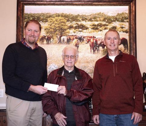 North Rock Creek Superintendent Blake Moody accepts a $6,500 check from Pottawatomie County Facilities Authority Chairman Leonard Taron and Vice-Chairman Tom Wilsie on Dec. 14. The funds will go toward playground equipment at the school’s on-site faculty daycare, Cougar Care. Photo provided by Matt Stephens.