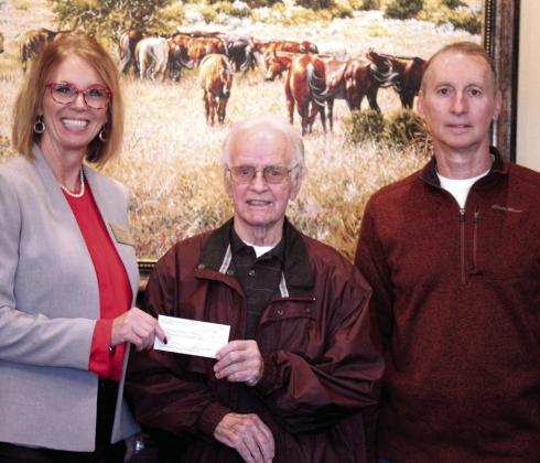 On Dec. 14 at West Law Firm in Shawnee, McLoud Superintendent Rhonda Hockenbury accepts a $6,500 check from Pottawatomie County Facilities Authority Chairman of the Trust Leonard Taron and Vice-Chairman Tom Wilsie to go toward buying microphones and a speaker for McLoud High School’s plays. Seven schools in the county were chosen to receive funding for their projects. Countywide &amp; Sun/ Natasha Dunagan