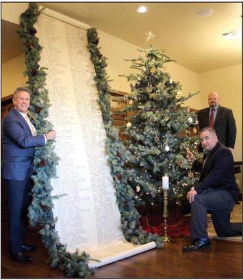 J. Cooper, Don Henson, and Landon Qualls pose with the Scroll of Honor and the Christmas Tree of Remembrance at Cooper Funeral Home in Tecumseh. Cooper Funeral Home will present “A Christmas Keepsake” program in the chapel for the 31st year on Dec. 4 at 2 pm. The families of those served by Cooper this year are invited to attend.