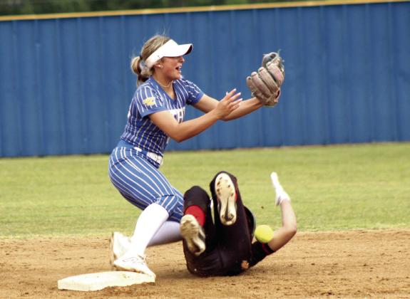 Bethel junior Bailey Tucker tries for the catch at second - as the Okmulgee runner collides with her, leaving them both on the ground - during the first home game in the Class 5A District Slow Pitch Tournament on April 23. The Lady Wildcats won both games against Okmulgee, 13-0 and 15-1, to become District Champs.